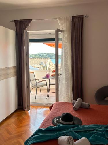 a bedroom with a bed and a view of a patio at Rooms Perina Tisno in Tisno