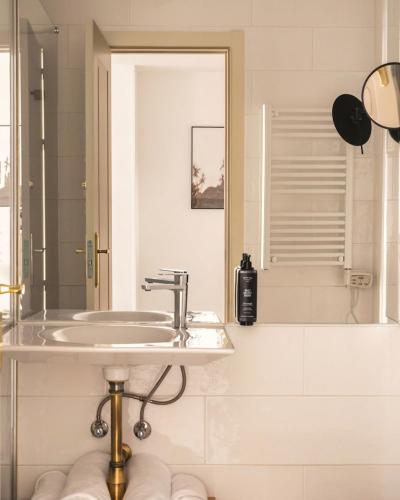a bathroom with a sink and a mirror at Limehome Madrid Sol in Madrid