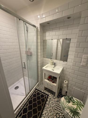 a white bathroom with a shower and a sink at GREEN HOUSE Hostel in Krakow