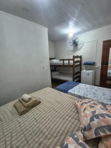 a bedroom with a bed with a towel on it at ECO BROTAS Pousada e Rafting in Brotas