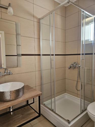 a bathroom with a shower and a sink at Rooms Perina Tisno in Tisno
