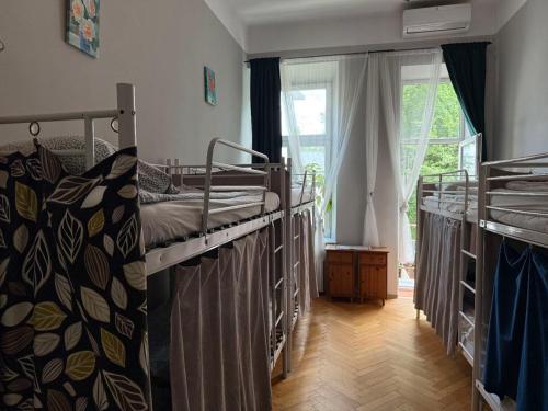 a bedroom with two bunk beds and a window at GREEN HOUSE Hostel in Krakow