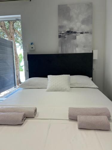a large white bed with two towels on it at Apartmani Milka i Jozo in Omiš