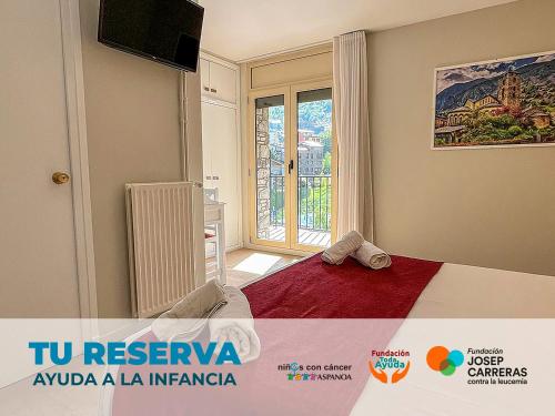 a bedroom with a bed with a television and a window at Hotel Pere D'Urg 3000 in Encamp