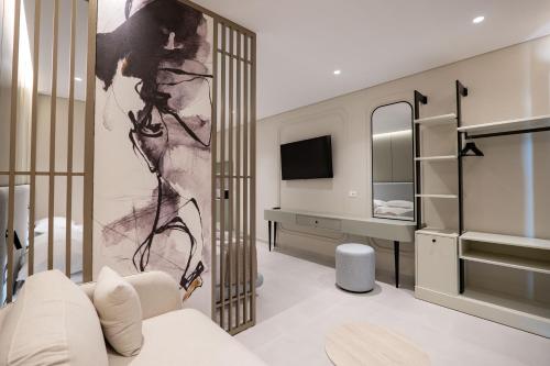 a living room with a white couch and a tv at Marea Suites Borsh in Borsh