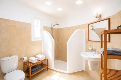 a bathroom with a shower toilet and a sink at Yakinthos Suites in Mykonos