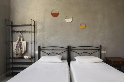 two beds sitting next to each other in a bedroom at Mazi in Sifnos in Sifnos