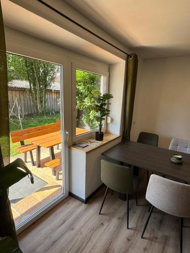 a dining room with a table and a sliding glass door at Moderne große Wohnung mit Garten in Hausham