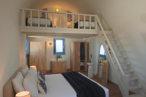 a bedroom with a bunk bed and a staircase at White Pearl Laokasti Suites in Oia