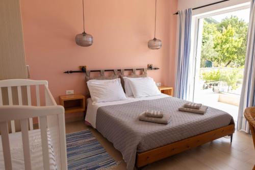 a bedroom with a bed with two towels on it at ELÉA Guesthouse himare in Himare