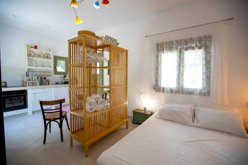 a bedroom with a bed and a wooden book shelf at Topos Patela in Kalithies