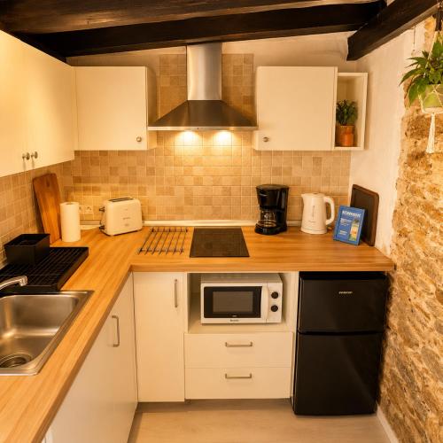 a kitchen with white cabinets and a stove top oven at Vejer de la Frontera Luis in Vejer de la Frontera