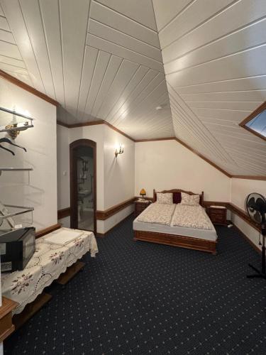 a bedroom with two beds and a ceiling at Veszprémvölgyi Kúria in Veszprém