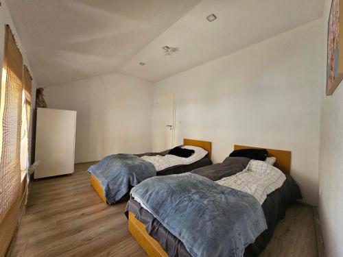 a room with two beds in a room with at Peja Riverside Hostel in Peje