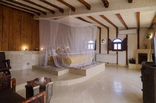 a large room with a bed in the middle of it at Kasbah Hotel Tombouctou in Merzouga
