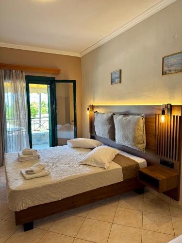 a bedroom with a large bed with towels on it at Hotel Filoxenia in Ligia