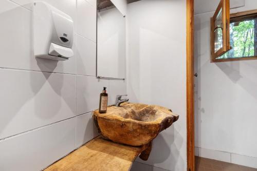 a bathroom with a stone sink in the corner at Cabane Le Module in Angoisse