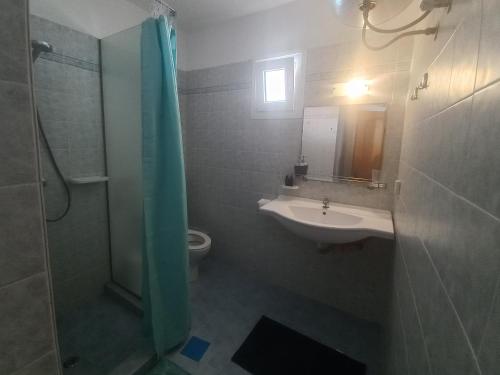 a bathroom with a sink and a shower and a toilet at Apartment Kasper in Skiathos