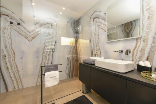a bathroom with a sink and a mirror at Villa Casara Design and Relax Lago di Garda in Costermano
