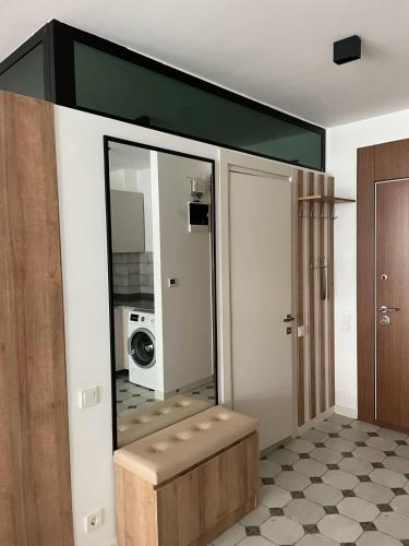 a bathroom with a mirror and a microwave on the wall at Batumi Sea View in Batumi