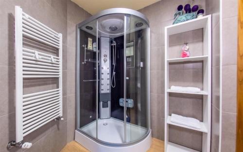 a shower with a glass door in a bathroom at Casa da Bia - Gerês in Terras de Bouro