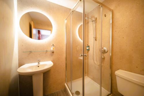 a bathroom with a sink and a shower at Claremont Hotel - All Inclusive! in Blackpool