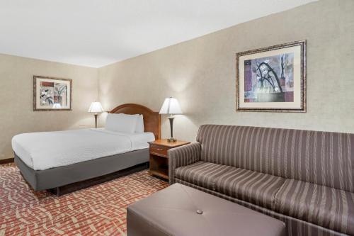 a hotel room with a bed and a couch at Rodeway Inn Columbia Mall Loop in Grand Forks