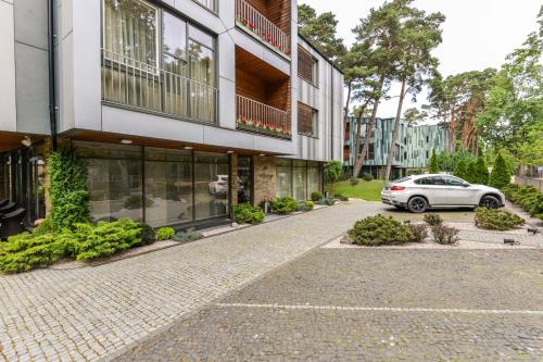 a car parked in front of a building at Guest House Aštuoni in Palanga