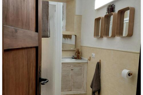 a small bathroom with a sink and a mirror at 2-Bed Country House - Mountain Views - Sleeps 6 in Rute