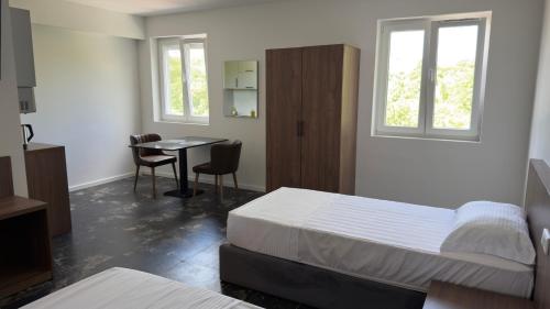 a bedroom with a bed and a table and windows at CHM Boarding Worms in Worms