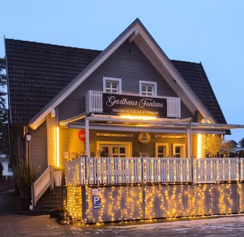 a restaurant with a fence in front of a building at Gasthaus Fontane GmbH in Wildau