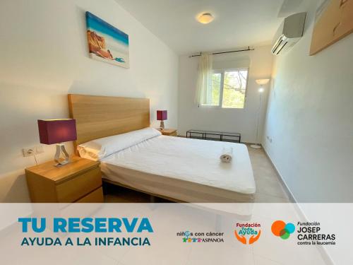 a small bedroom with a bed and a window at Apartamentos Neptuno 3000 in Alcossebre