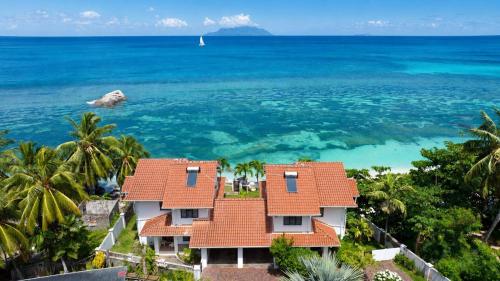 a house on the beach with the ocean at Beach View Villa - Beauvallon villas in Beau Vallon