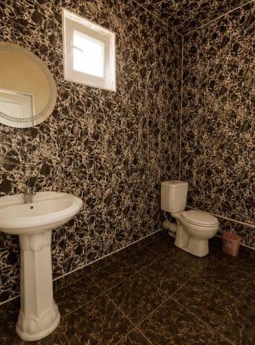 a bathroom with a sink and a toilet at Guesthouse Tornike in Gonio