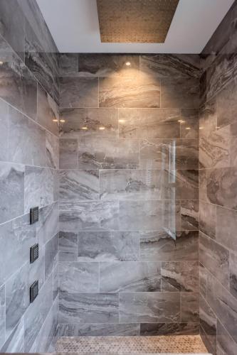 a bathroom with a stone wall at Sweet Lancaster Apt. B in Lancaster