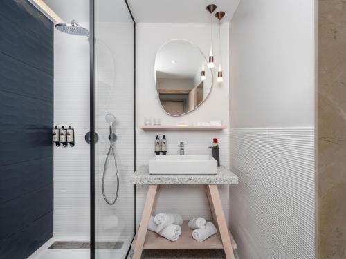 a bathroom with a sink and a shower at Atlas Essaouira Riad Resort in Essaouira