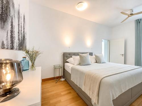 a bedroom with a large bed with white sheets at Schwarzwald Loft Baden-Baden in Baden-Baden