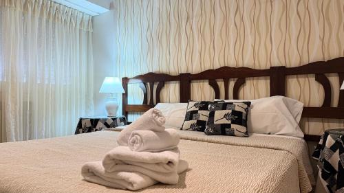 a bedroom with a bed with two towels on it at Gran Hotel Mar del Plata in Mar del Plata