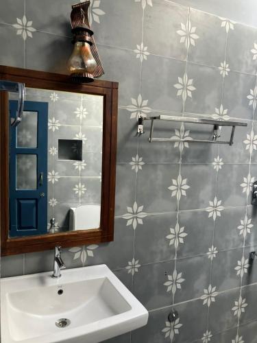 a bathroom with a sink and a mirror at Aali villas in Mararikulam