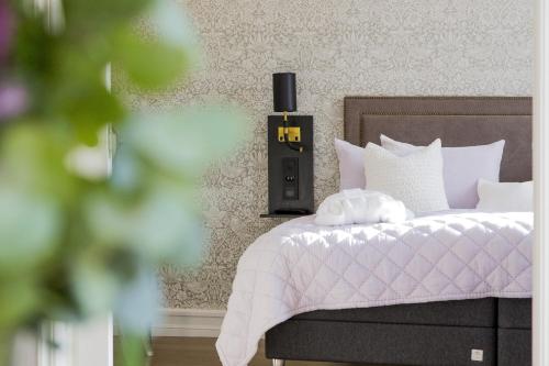 a bedroom with a bed with a white comforter at Continental du Sud in Ystad