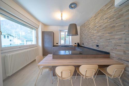 a kitchen with a wooden table and chairs at Spinedi Royale in Postalesio