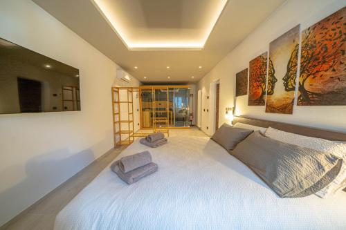 a bedroom with a large white bed with two pillows at Spinedi Royale in Postalesio