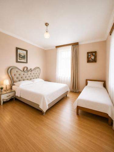 a bedroom with two beds and a window at Guesthouse Tornike in Gonio