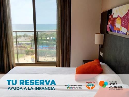 a hotel room with a bed with a view of the ocean at Alcocebre Suites Hotel in Alcossebre