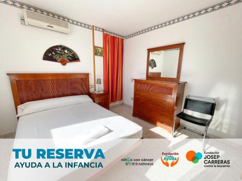 a bedroom with a bed and a dresser and a television at Apartamentos Costa Azahar 3000 in Alcossebre