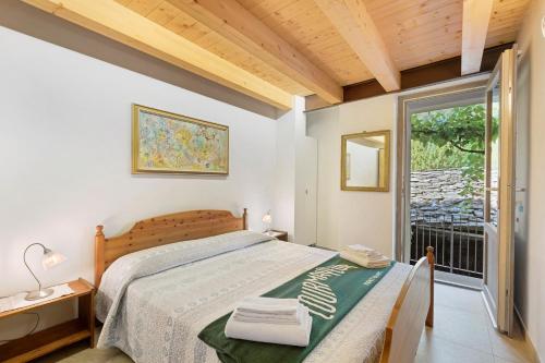 a bedroom with a bed and a large window at Maison Jaccod Apartments in Morgex
