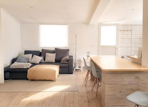 a living room with a couch and a table at Comfortable Studio in Santiago do Cacém, private pool, 65 m² in Santiago do Cacém