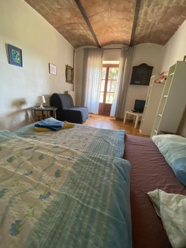a bedroom with a large bed and a living room at Atelier Suvereto in Suvereto
