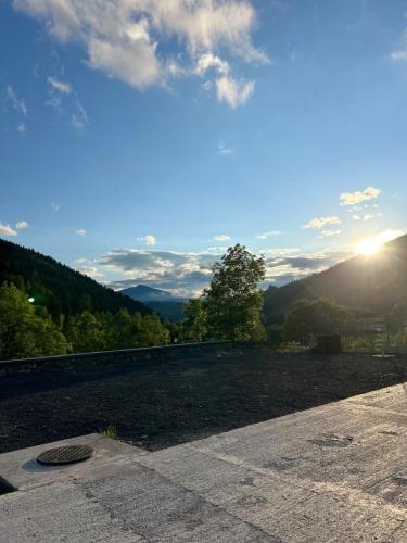 a view of a hill with the sun in the sky at Casa Roua Munților in Dămuc