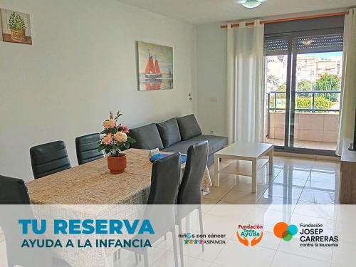 a living room with a couch and a table at Apartamentos Playa de Benicarló 3000 in Benicarló
